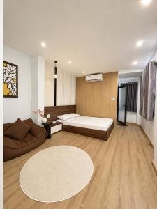 a living room with a bed and a couch at Linh's Home in Danang