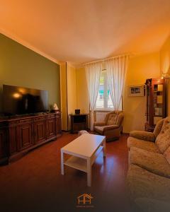 a living room with a couch and a tv at La Cameranense by Homes in Ancona in Camerano