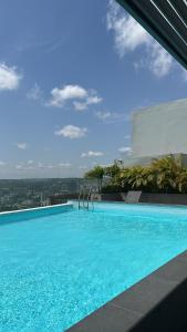 a large blue swimming pool on top of a building at Luxury Studio Condo in Accra