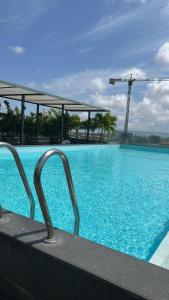 a large swimming pool with a crane in the background at Luxury Studio Condo in Accra +7 photos