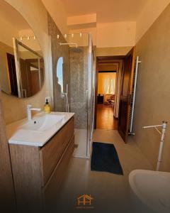 a bathroom with a sink and a shower and a mirror at La Cameranense by Homes in Ancona in Camerano +5 photos
