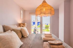 a living room with a couch and a chandelier at Los Altos in Almuñécar +37 photos