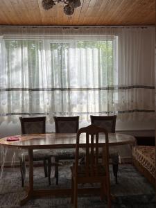 a dining room with a table and a window at Village stay in Kaindy