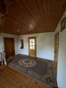 an empty room with a large rug on the floor at Village stay in Kaindy