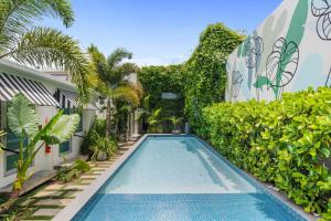 a swimming pool in the courtyard of a house with plants at The Weekender Hotel in San Juan +80 photos
