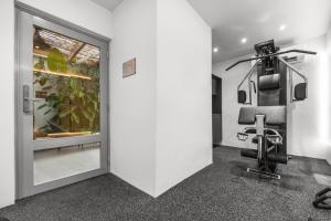 a room with a gym with a chair in it at The Weekender Hotel in San Juan