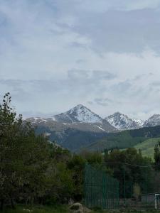 a view of a mountain range with snow covered mountains at Village stay in Kaindy