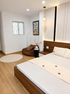 a bedroom with a large bed in a room at Linh's Home in Danang +7 photos