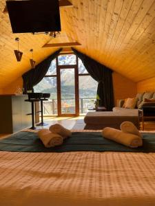 two beds in a room with a large window at Cabin AISI in (( Gergeti ))