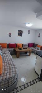 a living room with a couch and a table at Isco Stam in Martil