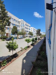 a street in a city with a building at Isco Stam in Martil