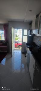 a kitchen with a door open to a living room at Isco Stam in Martil +4 photos