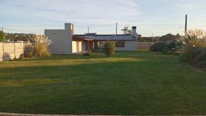 a house in a yard with a grassy yard at Villa Pi in Miramar