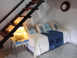 a bedroom with a bed and a staircase with a lamp at La Casa de Sol in Posadas