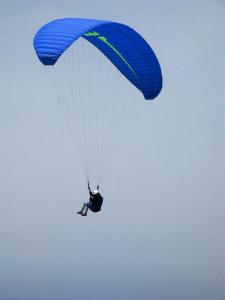 a person riding a parachute in the sky at Al Sole Apartment in Locca +13 photos