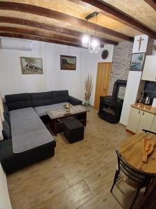 a living room with a couch and a table at Kuća za odmor Buk in Čapljina +32 photos
