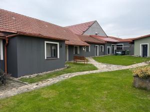 a row of houses with a green yard at Penzion u Valešů in Mohelno +5 photos