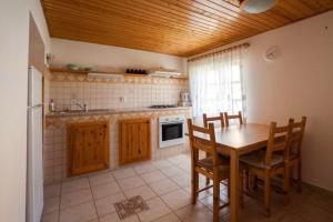 a kitchen with a table and chairs and a stove at Penzion u Valešů in Mohelno