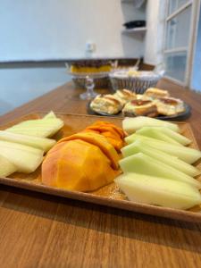 a tray of food on a table with cheese and onions at Central Suites - Hospedagem Super Econômica in Rio Verde +5 photos