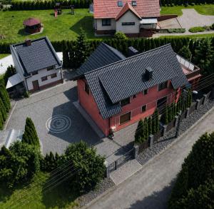 an overhead view of a red house with a driveway at Cozy Cottage in Oświęcim