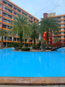 a large blue swimming pool in front of a building at Sunset view apartment with a pool MAIKHAO Phuket in Ban Mai Salae