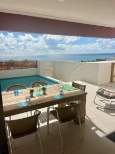 a dining room with a table and a swimming pool at Ben's Gem in Philipsburg