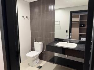 a bathroom with a toilet and a sink at Hotel Plaza Belmar by HCC in Campo Grande +35 photos