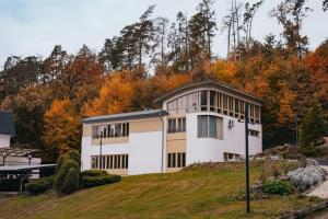 a house on top of a hill with trees at Apartmány U Libuše in Lultsch