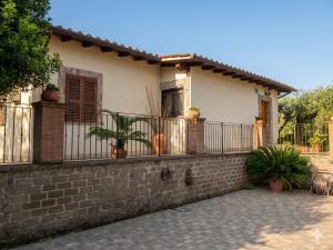 a house with a fence and potted plants on it at Greta's Villa in Velletri