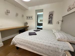 a bedroom with a bed with a white comforter at L'Appart D'Oli et Tiane in Bordeaux