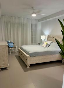 a bedroom with a bed and a chair and a window at Ben's Gem in Philipsburg +39 photos