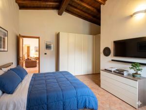 a bedroom with a large blue bed and a flat screen tv at Greta's Villa in Velletri +28 photos
