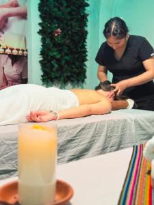 a woman laying on a bed getting a massage at Avraham Hotels in Machu Picchu
