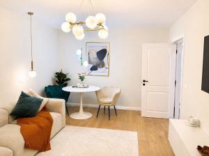 a living room with a couch and a table at A&K Apartament in Bacău