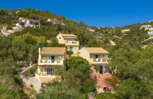 a group of houses on a hill with trees at Bay View Hotel in (( Klonátika ))