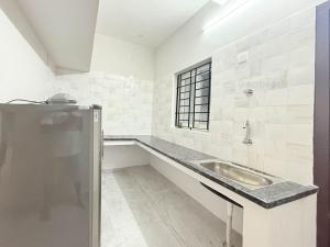 a bathroom with a sink and a window at Sea shell in Covelong +11 photos