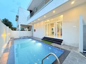 a swimming pool in the backyard of a house at Sea shell in Covelong