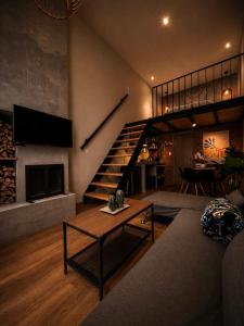 a living room with a staircase and a fireplace at Cabañas Boutiques TinyChillHouse in Mineral del Chico