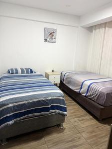 a bedroom with two beds in a room at Comodidad en un solo lugar in Lima