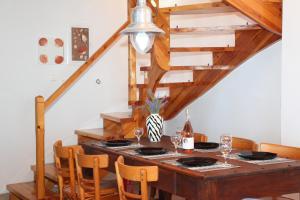 a dining room with a wooden table and chairs at Villa Panorama in Kalamitsi