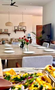 a dining room with a table with plates of food at Villa Paraiso in Holbox Island +24 photos