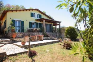 a house with a stone staircase in front of it at Villa Panorama in Kalamitsi