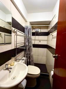 a bathroom with a sink and a toilet at Comodidad en un solo lugar in Lima +8 photos