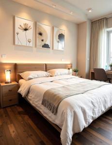 a bedroom with a large bed with three paintings on the wall at Albergo Conca D'Oro in Foggia +24 photos