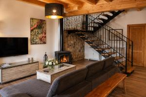 a living room with a couch and a staircase at Casa Luenga in Vinuesa