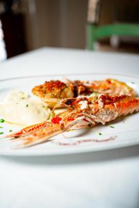 a plate of food with shrimp and eggs on a table at Albergo Conca D'Oro in Foggia