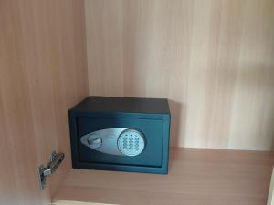 a small television with a remote control inside of it at Neptune Resort in Kavos