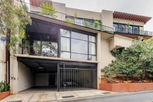 an apartment building with a garage and a balcony at Villa del Carmen in Colorines +2 photos