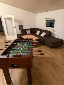 a living room with a pool table and a couch at Monteurwohnung in Runkel