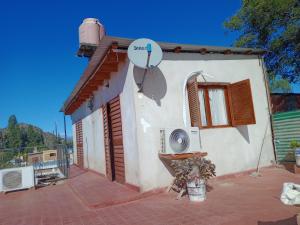 a house with a satellite on the side of it at Duplex Hermosinda Hospedaje in Chilecito